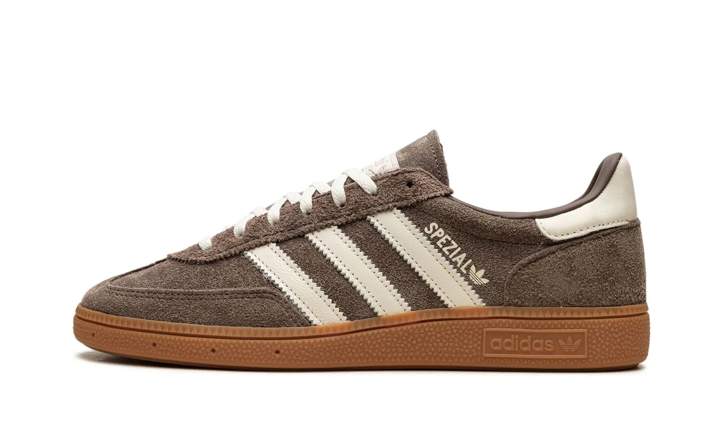 Adidas Handball Spezial 'Earth Strata' featuring a rich brown suede upper with off-white stripes and a dark gum sole. Classic terrace sneaker available at our Malmö store.