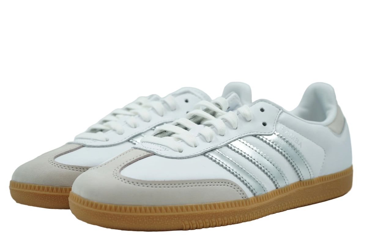 Pair of adidas Samba OG in white leather with silver metallic stripes and grey suede toe, front view