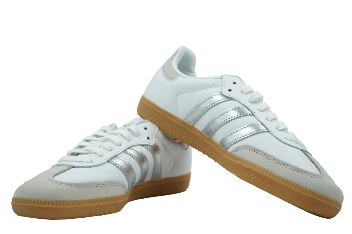 Pair of adidas Samba OG in white leather with silver metallic stripes, grey suede toe and gum soles