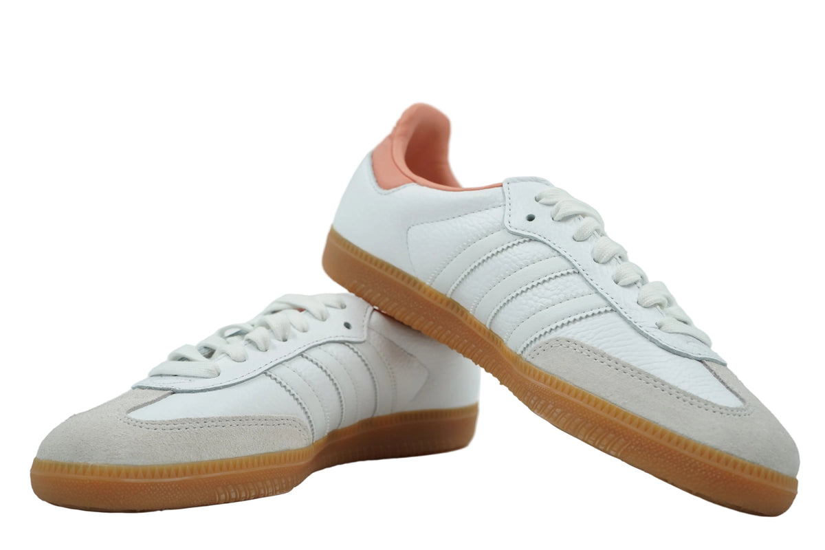 Pair of women's adidas Samba OG showing tonal white stripes on inner side, grey suede toe and gum sole