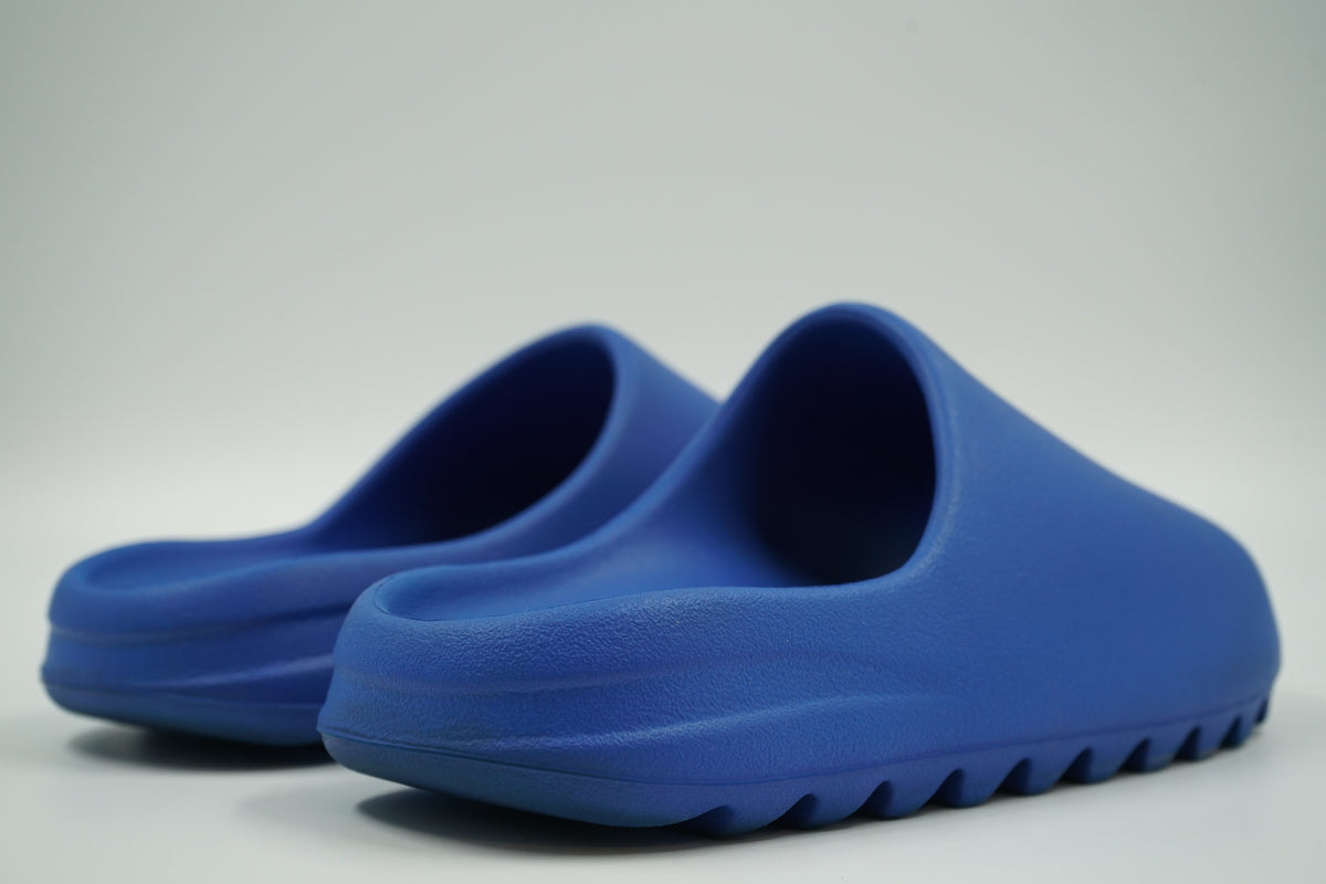 Pair of pre-owned adidas Yeezy Slides in Azure blue foam, back view of heels
