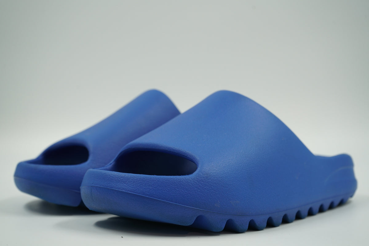 Pair of pre-owned adidas Yeezy Slides in Azure blue moulded foam, front angle view