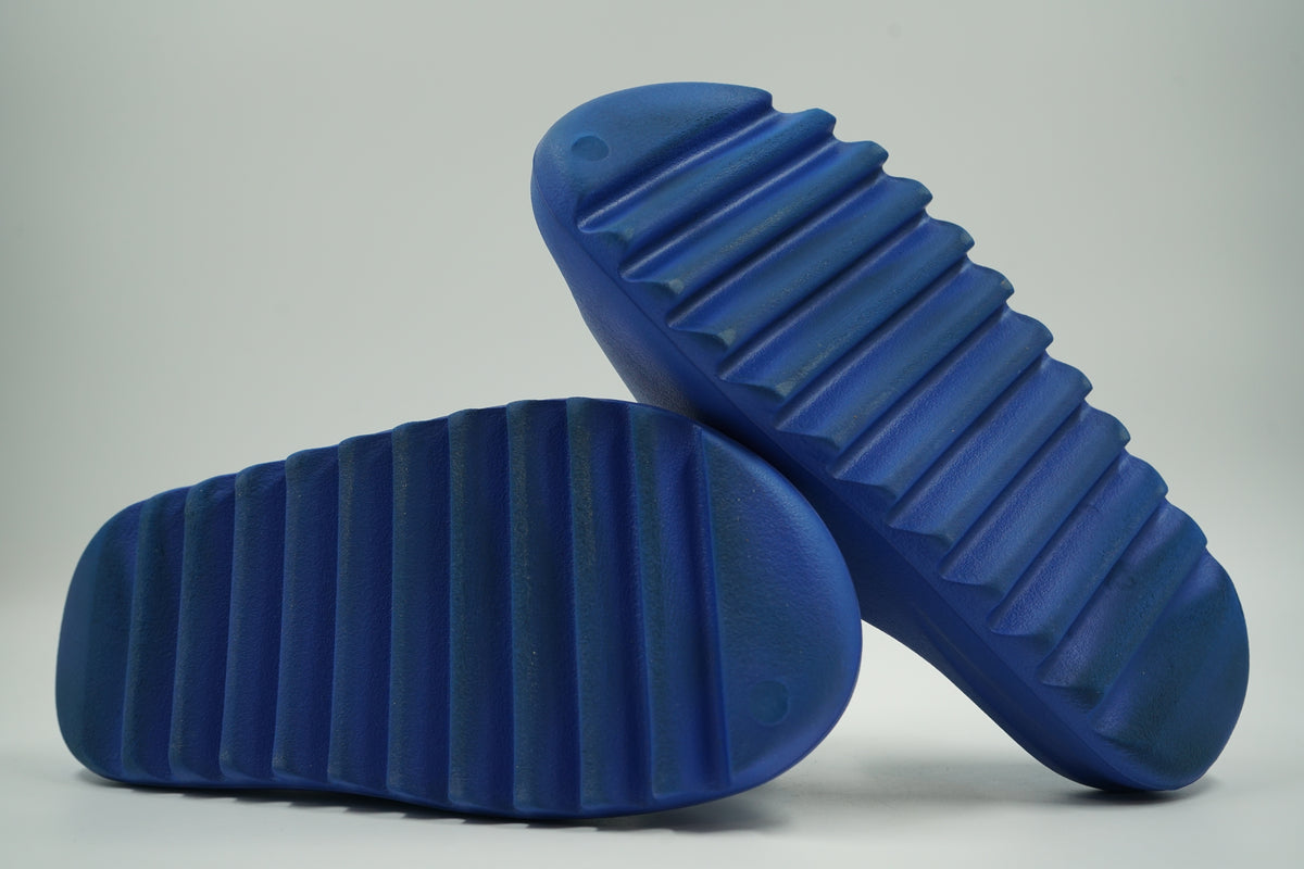 Pre-owned adidas Yeezy Slide in Azure blue, outsole view with deep ridged foam tread