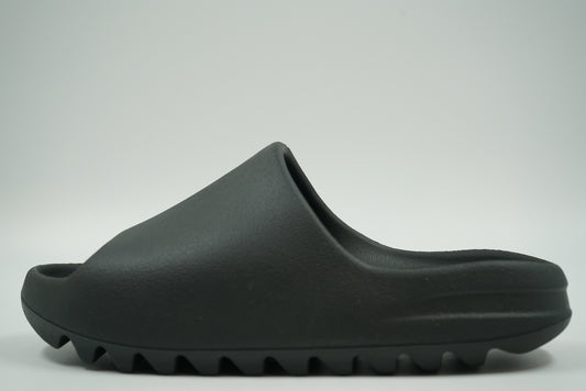 Pre-owned adidas Yeezy Slide in Dark Onyx moulded foam with ridged sole, side view