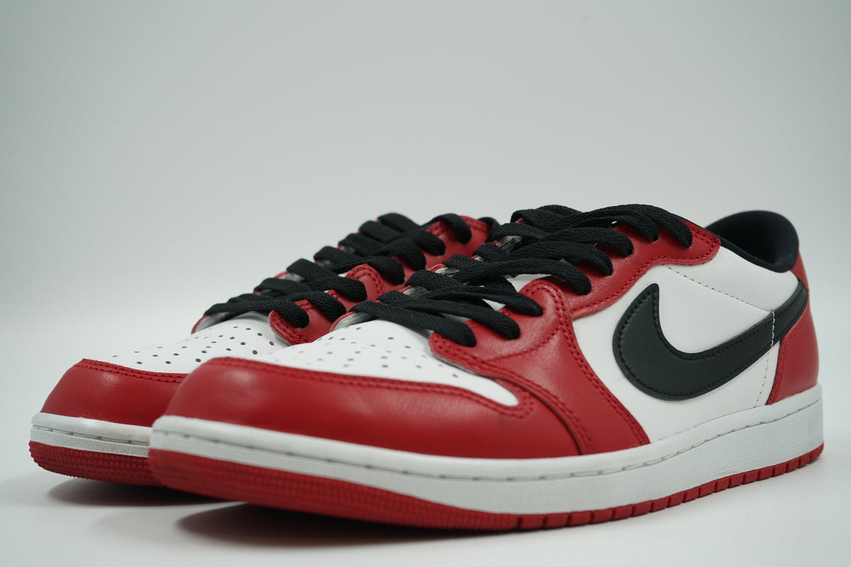Pair of pre-owned Air Jordan 1 Retro Low OG Chicago 2025 in red, white and black leather, front angle