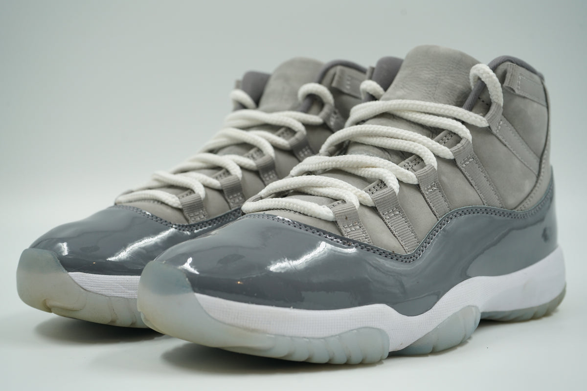 Pre-owned pair of Air Jordan 11 Cool Grey 2021 with grey patent leather toe and white rope laces, front view