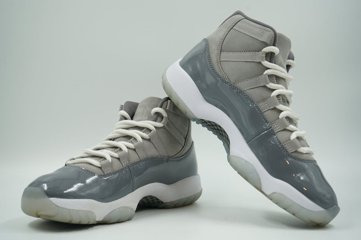 Pre-owned pair of Air Jordan 11 Cool Grey 2021 in grey nubuck and patent leather with icy sole, side view