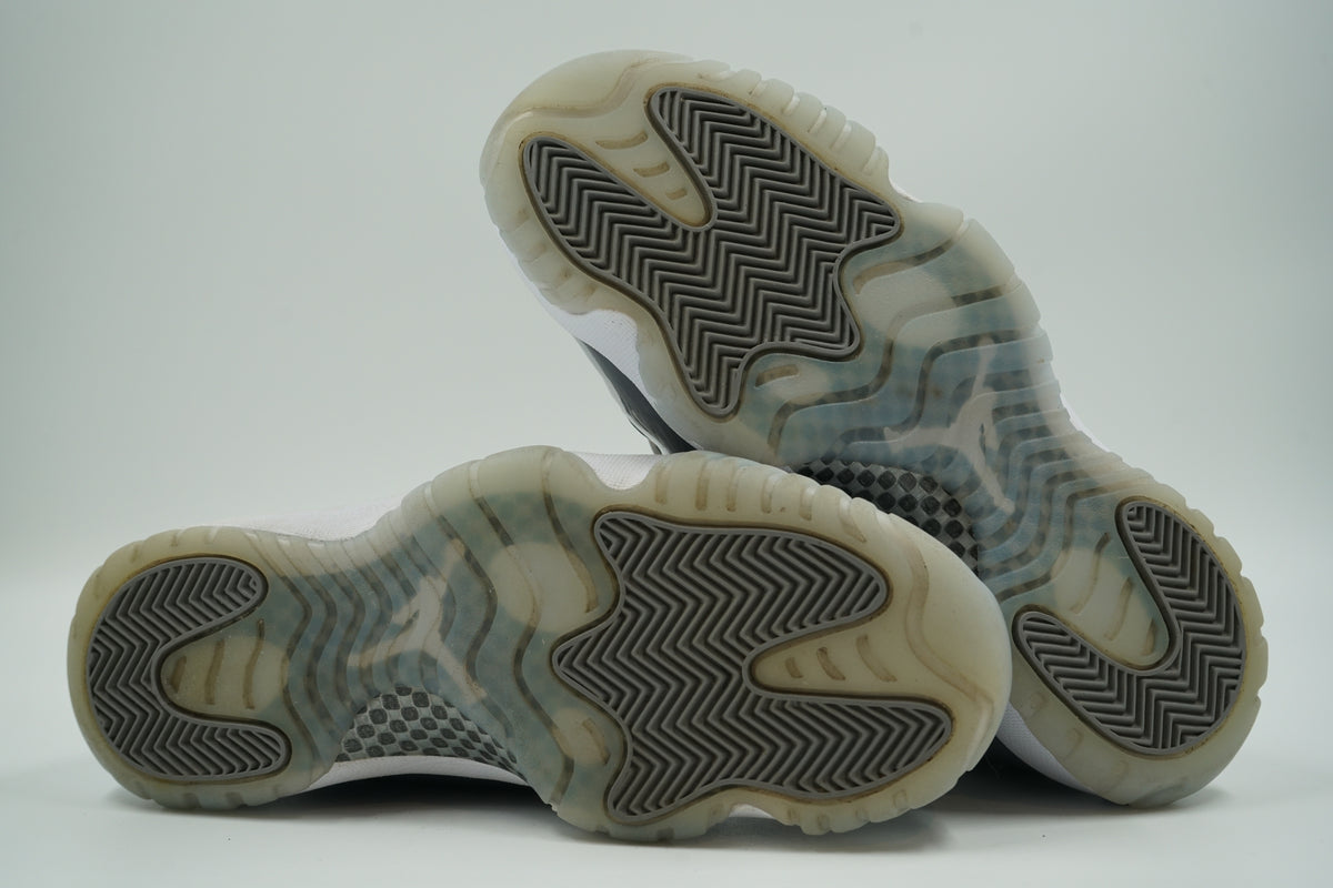 Outsoles of pre-owned Air Jordan 11 Cool Grey 2021 with icy translucent sole, light yellowing and wear