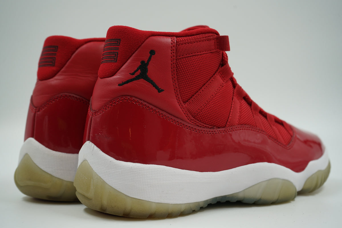 Pair of pre-owned Air Jordan 11 Retro Win Like 96 in Gym Red, back view with 23 heel tab and Jumpman