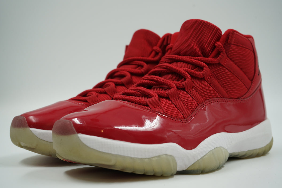 Pair of pre-owned Air Jordan 11 Retro Win Like 96 in Gym Red patent leather and mesh, front angle view