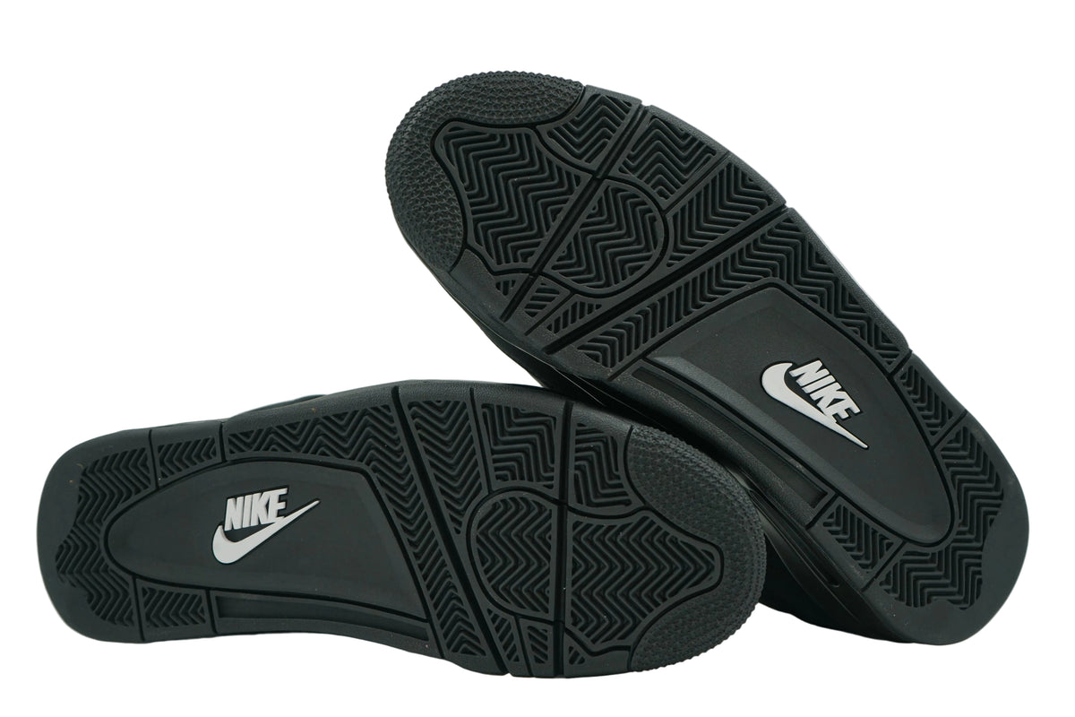 Unworn black outsoles of Air Jordan 4 Black Cat 2025 with white Nike logo and herringbone tread
