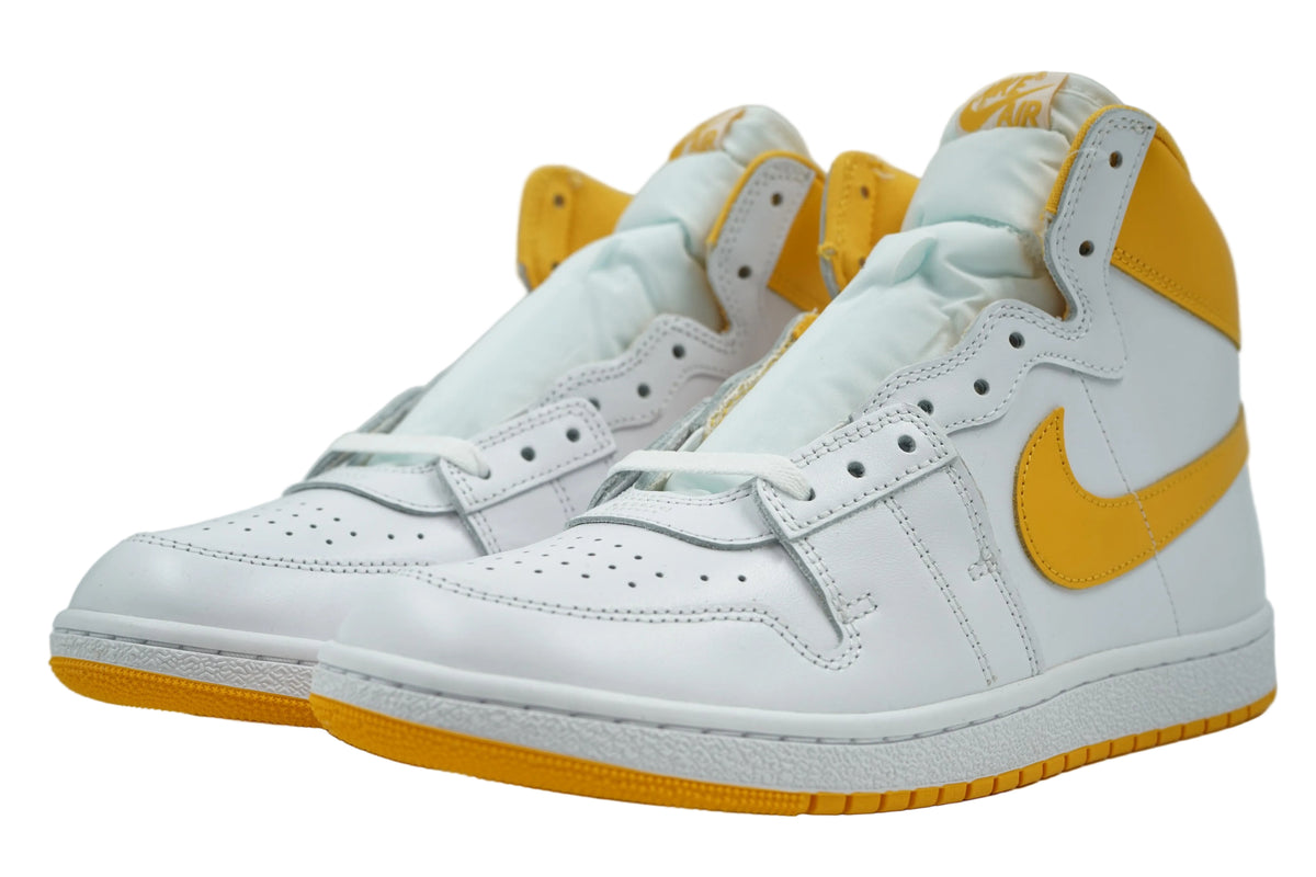 Pair of Jordan Air Ship PE SP University Gold with padded nylon tongue and Nike Air tongue tag, front view