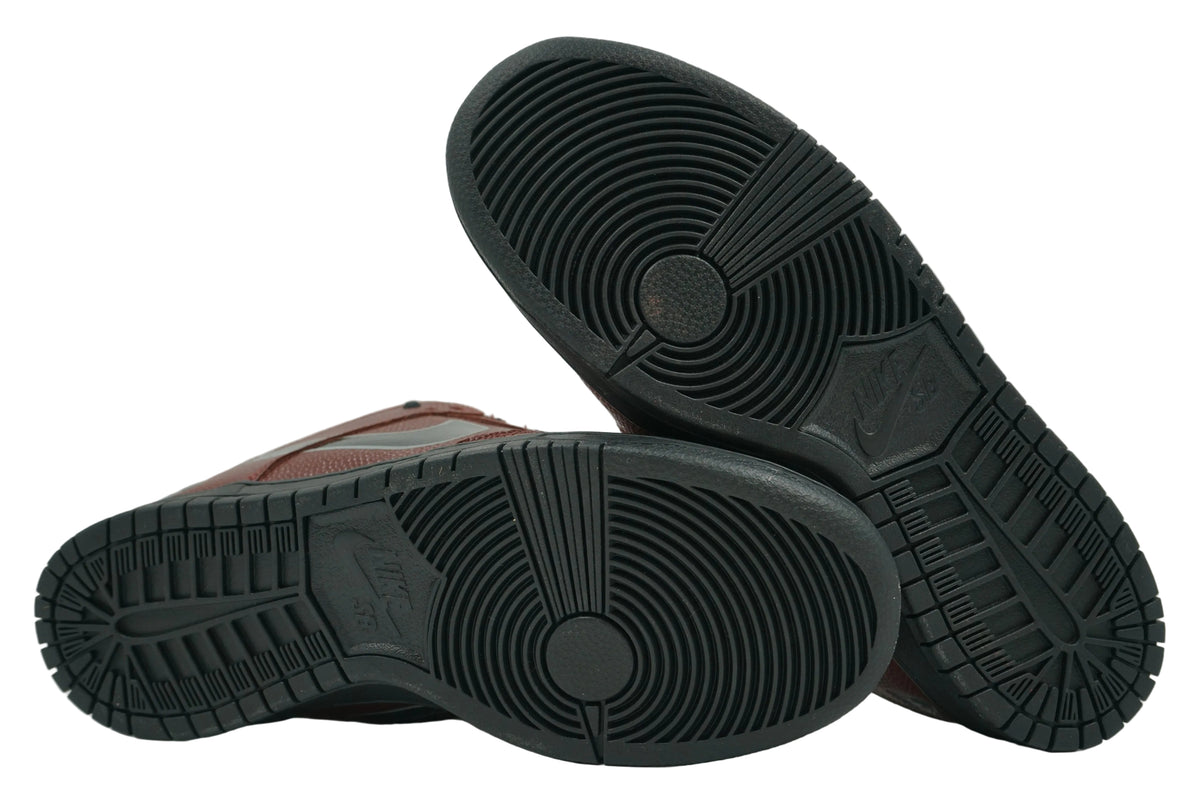 Unworn black outsoles of Limosine x Nike SB Dunk Low Football with Nike SB logo and full tread