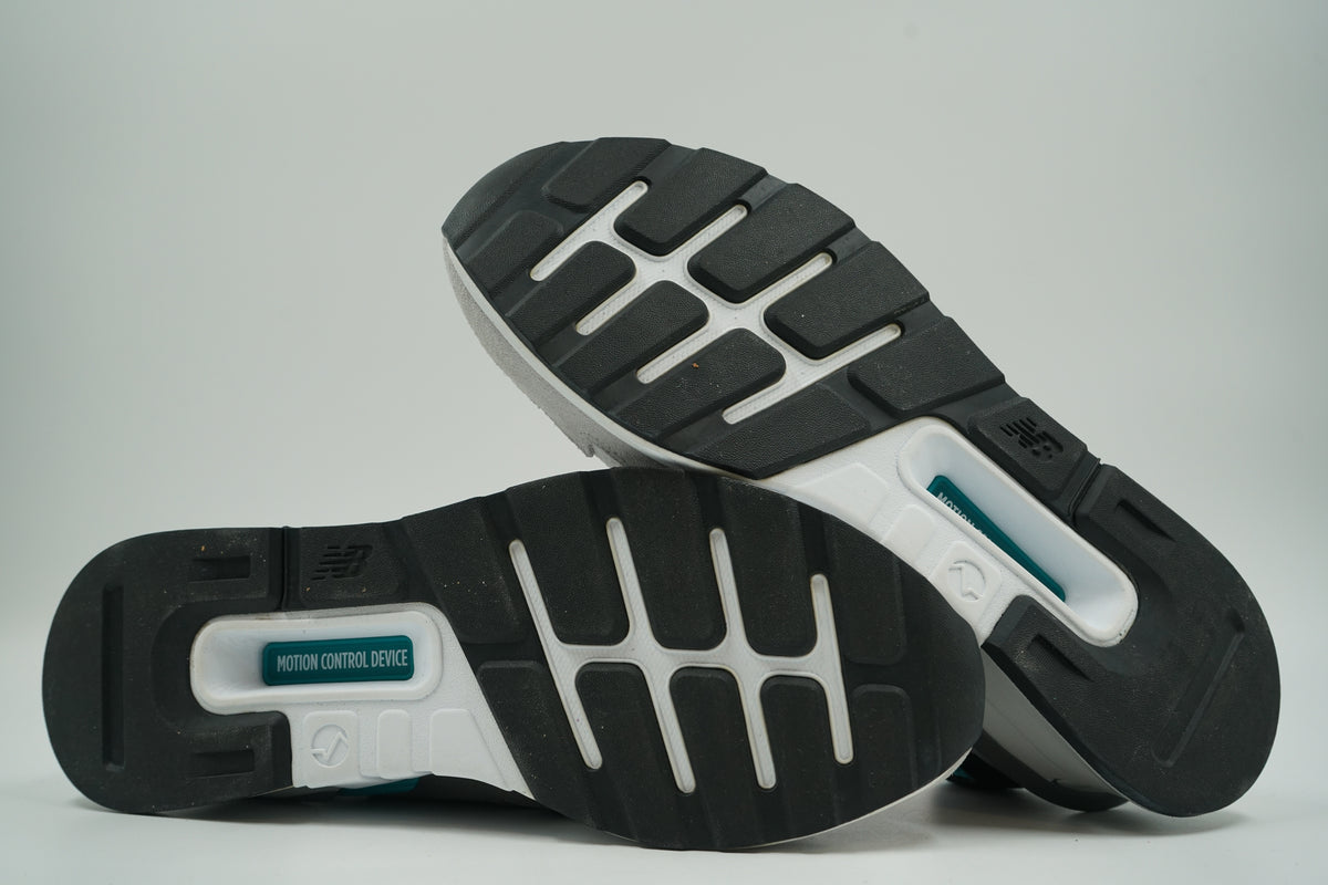 Pre-owned New Balance 997 Sport Castlerock Amazonite, outsole view with black rubber tread and teal motion control plate