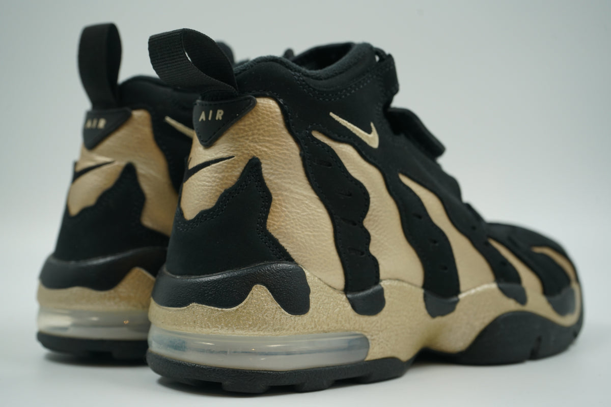 Pair of pre-owned Nike Air DT Max 96 in black and Vegas Gold, back view with Air heel tab and Max Air unit