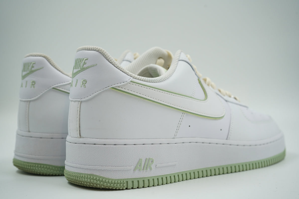 Pair of pre-owned Nike Air Force 1 ‘07 in white and honeydew, back view with embroidered Nike Air heel logo