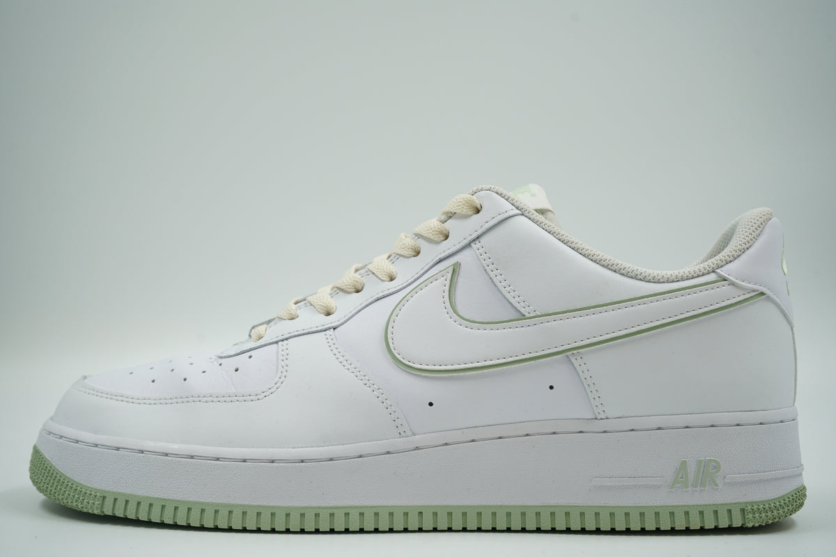 Pre-owned Nike Air Force 1 ‘07 Low in white with honeydew green outlined Swoosh and sole, side view