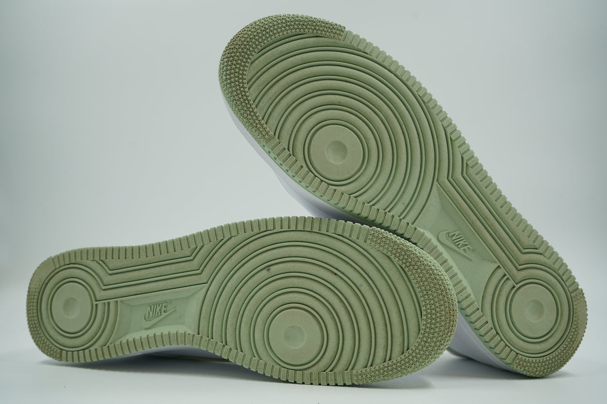 Pre-owned Nike Air Force 1 ‘07 in white and honeydew, outsole view with green tread and Nike logo