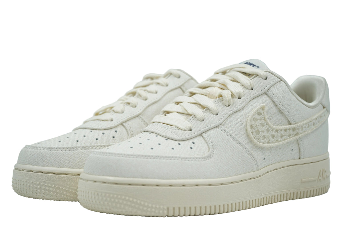 Pair of brand new Nike Air Force 1 Low in sail canvas with cream laces and textured Swoosh, front view