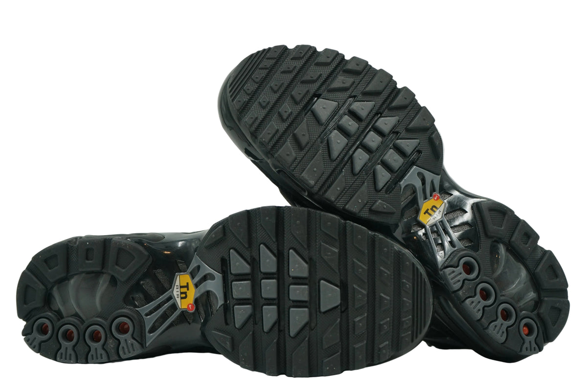 Unworn black outsoles of brand new Nike Air Max Plus TN with full tread and Tuned Air window