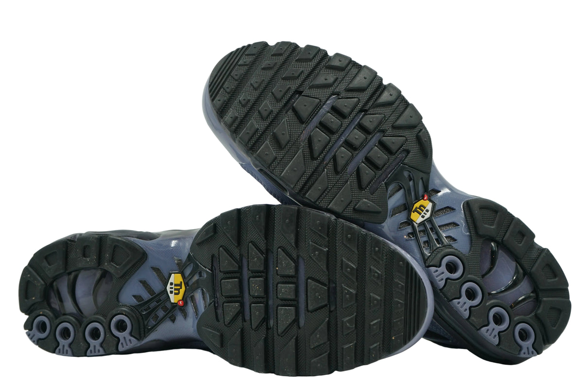 Unworn outsoles of brand new Nike Air Max Plus TN World Indigo with full tread and Tuned Air window