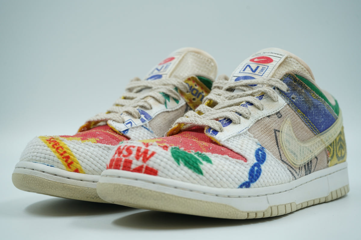 Pair of pre-owned Nike Dunk Low City Market sneakers with patchwork textile upper, front angle view