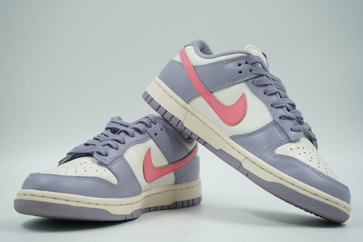 Pair of pre-owned women’s Nike Dunk Low Indigo Haze in sail and lavender, stacked view of inner sides