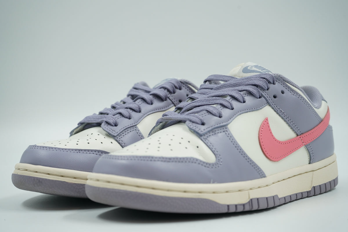 Pair of pre-owned women’s Nike Dunk Low Indigo Haze in sail and lavender with pink Swoosh, front angle