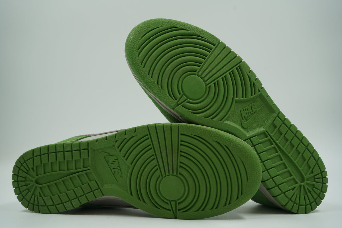 Pre-owned Nike Dunk Low Safari Swoosh in green and grey, outsole view with green tread and Nike logo