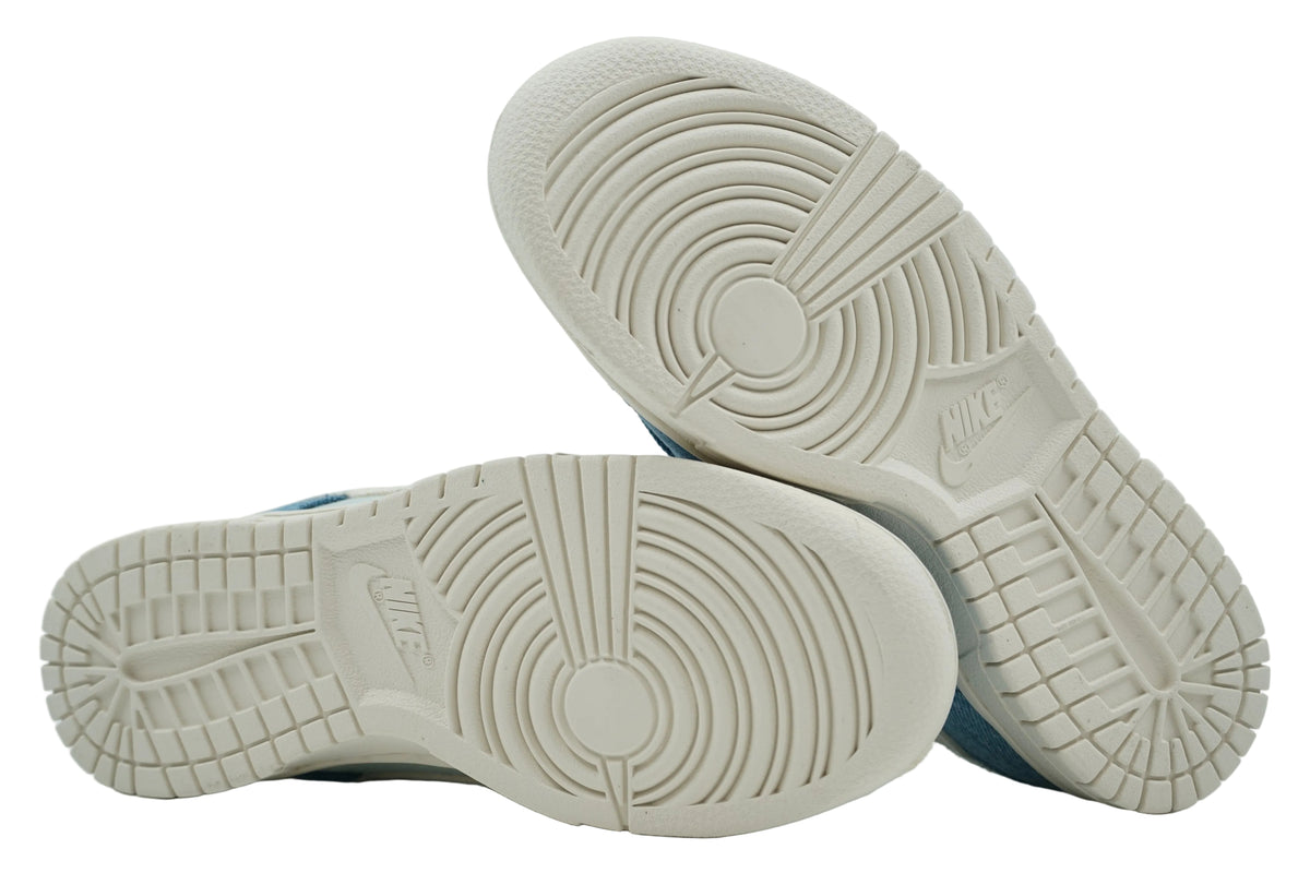 Unworn pale ivory outsoles of brand new Nike Dunk Low Smokey Blue Denim with full tread