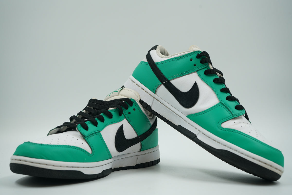 Pair of pre-owned Nike Dunk Low in Stadium Green, white and black, one shoe leaning on the other