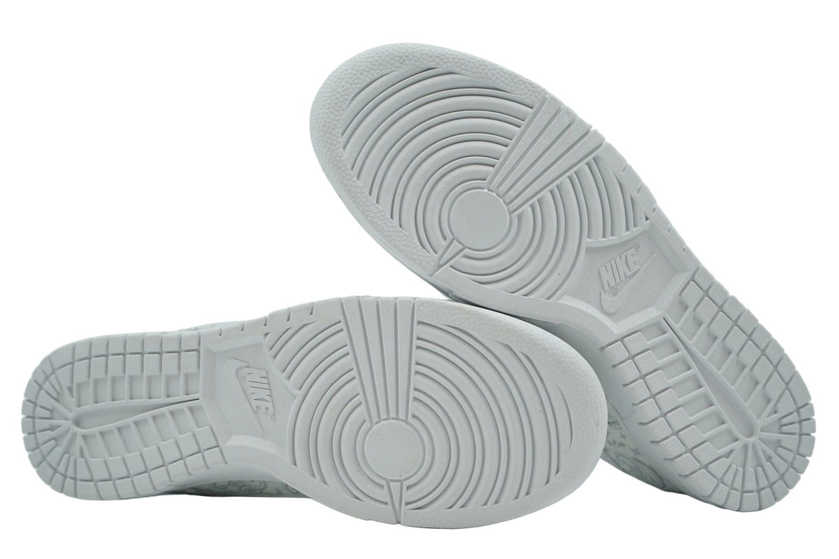 White outsoles of women's Nike Dunk Low White Paisley with pivot circle and Nike logo