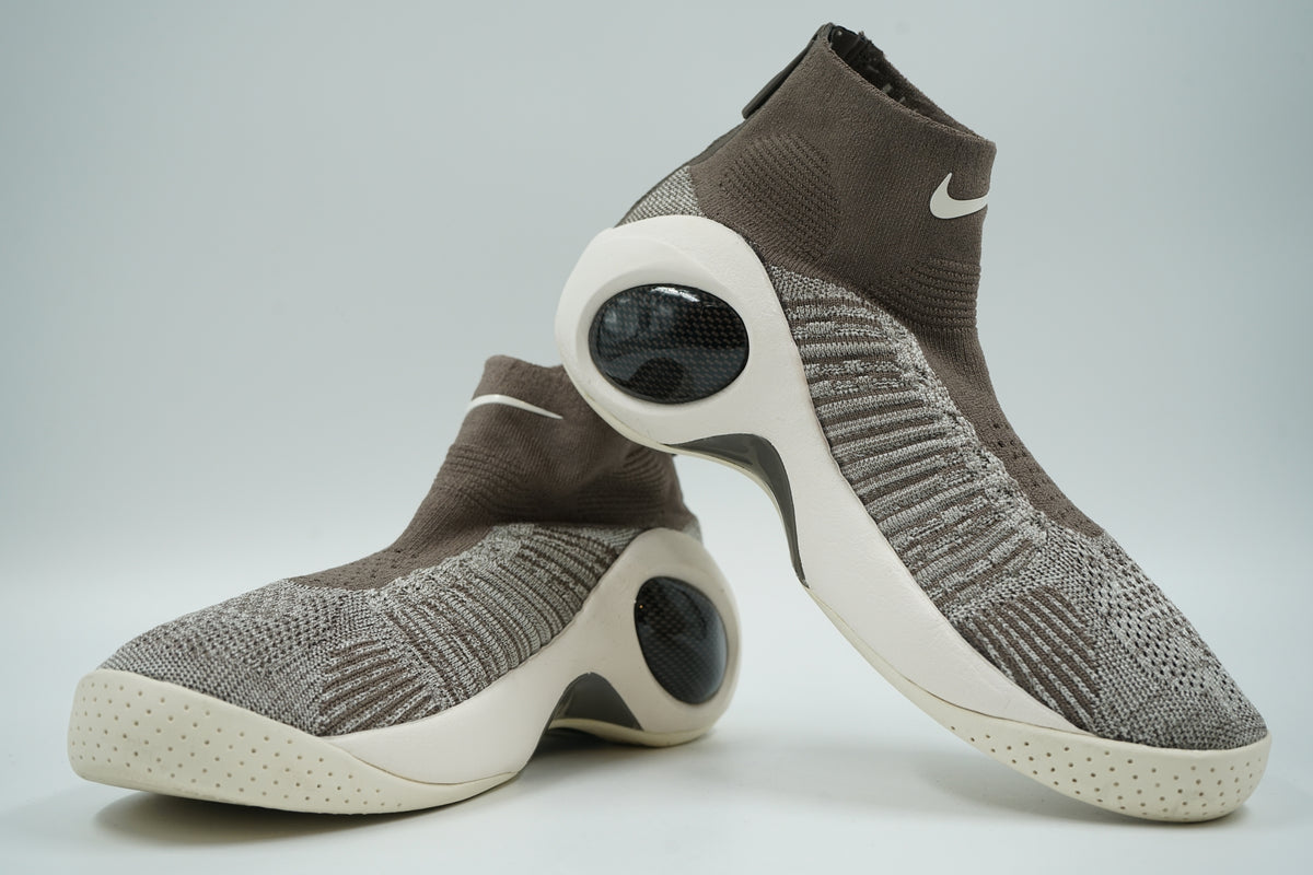 Pre-owned pair of Nike Flight Bonafide Dark Mushroom in grey Flyknit with sail midsole and Air pods, side view