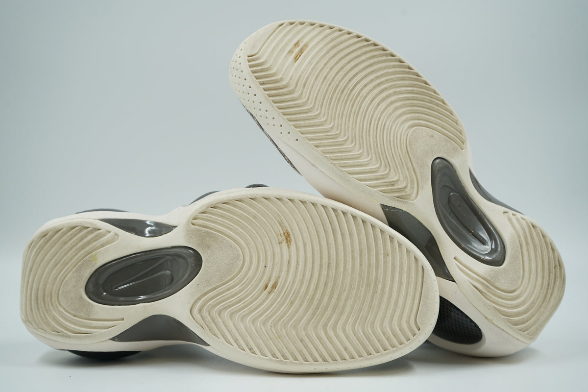 Outsoles of pre-owned Nike Flight Bonafide Dark Mushroom with sail wavy tread and grey Air units