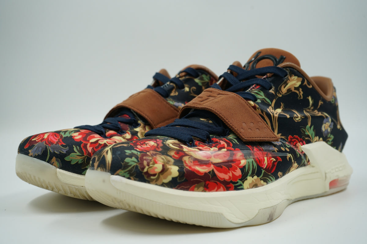 Pre-owned pair of Nike KD 7 EXT Floral with red and navy floral print and brown suede strap, front view