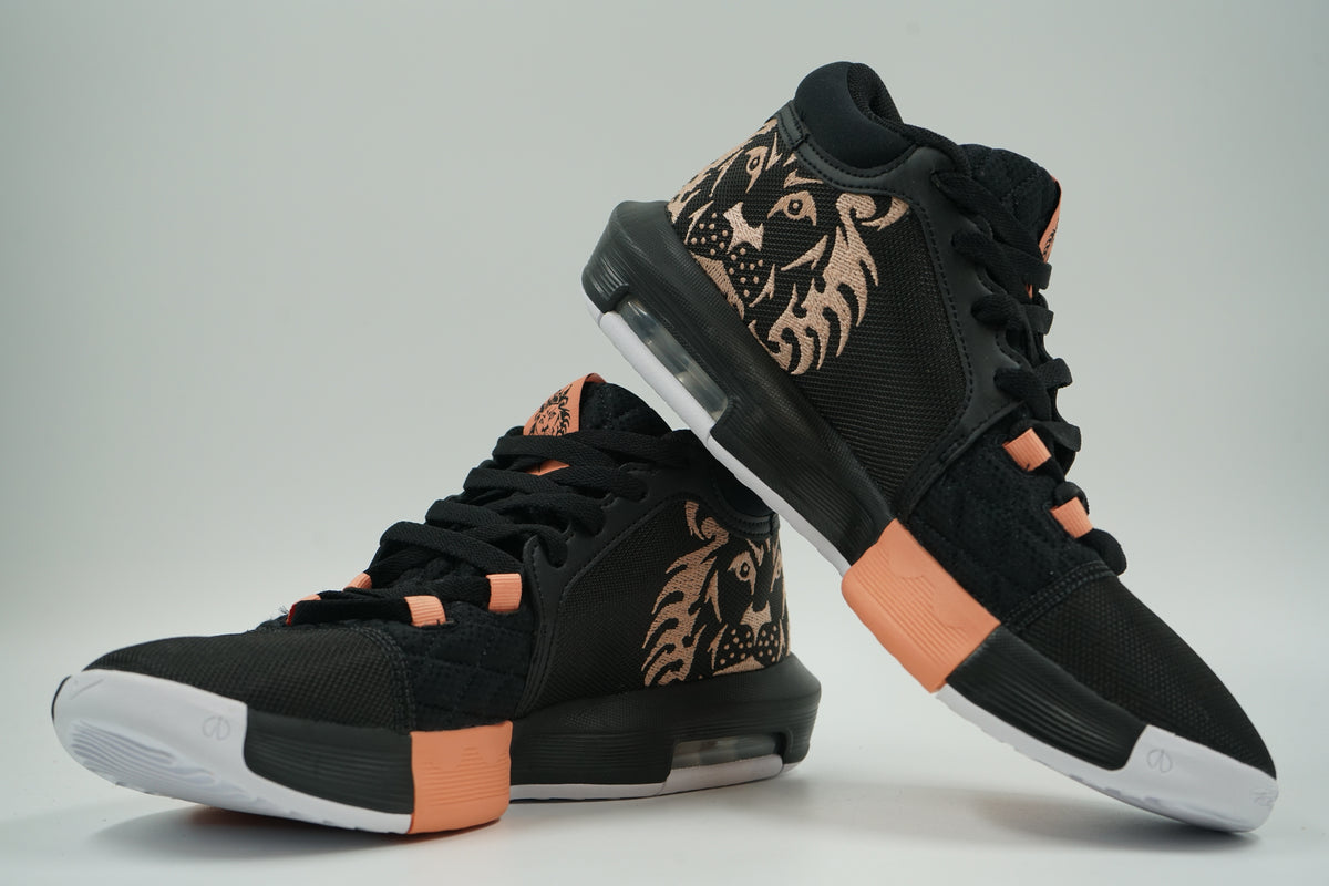 Pair of pre-owned Nike LeBron Witness 8 in black, inner side view with large embroidered peach lion head