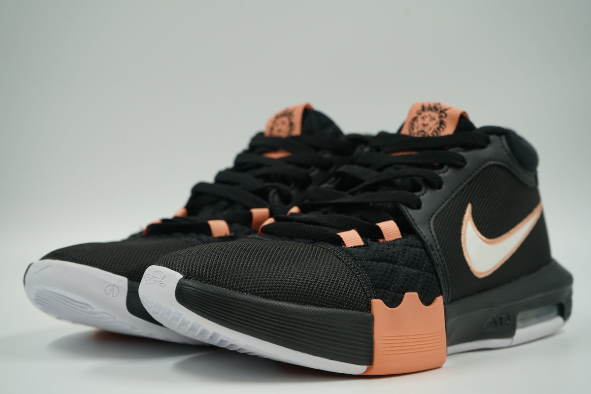 Pair of pre-owned Nike LeBron Witness 8 in black and peach with LeBron lion logo tongue, front angle view