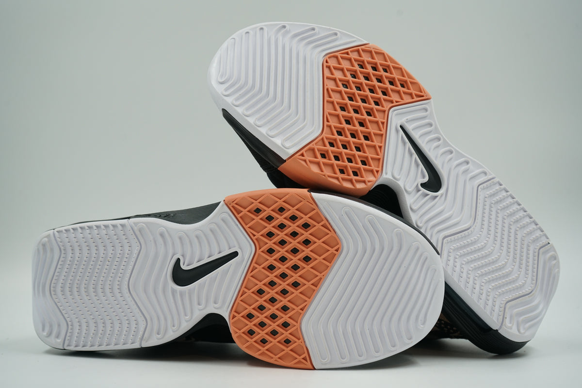 Pre-owned Nike LeBron Witness 8, white outsole view with herringbone tread, peach midfoot panel and Swoosh