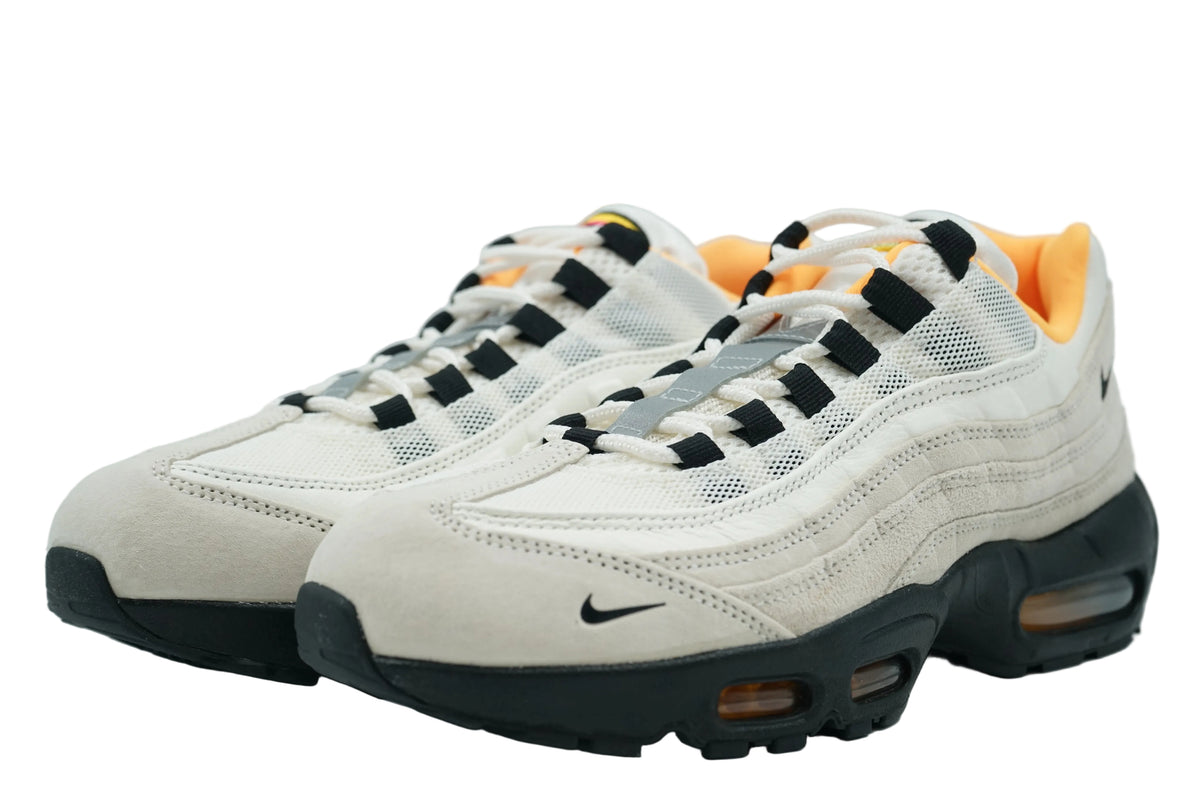 Pair of Nike SB Air Max 95 Club 58 in sail suede and mesh with black eyelets and laser orange lining, front view