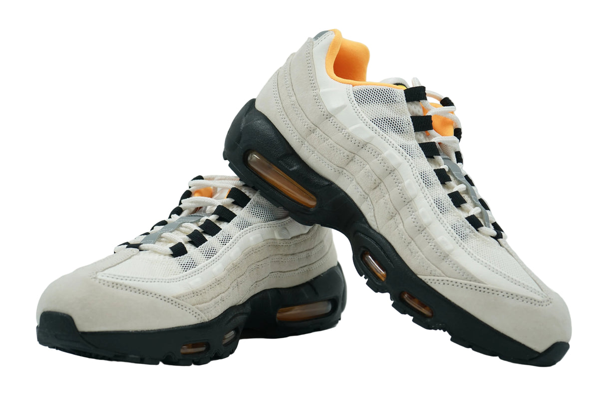 Pair of Nike SB Air Max 95 Club 58 in sail suede and mesh with black midsole and orange Air units