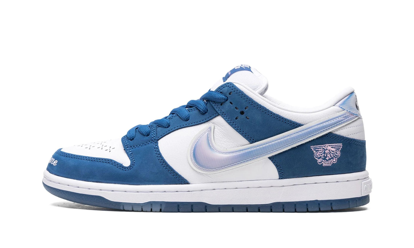 Nike SB Dunk Low x Born x Raised featuring deep royal blue nubuck overlays, a holographic Swoosh, and 'One Block at a Time' embroidered on the toe. Exclusive collaboration available at our Malmö store or order online now.