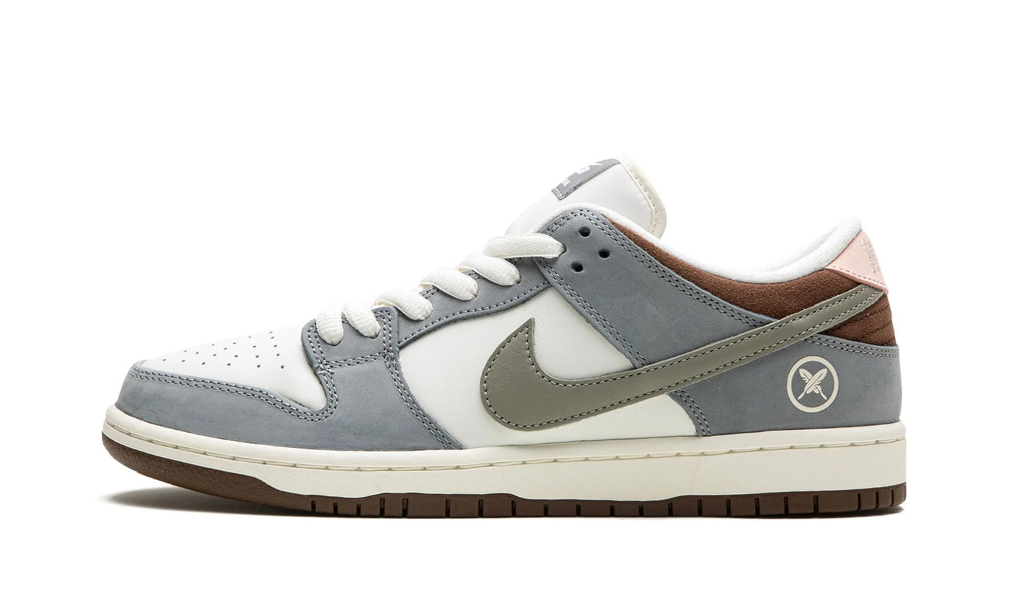 Nike SB Dunk Low x Yuto Horigome featuring Wolf Grey suede and signature cross-feather logo embroidery. Limited edition sneaker available at our Malmö store or order online now.