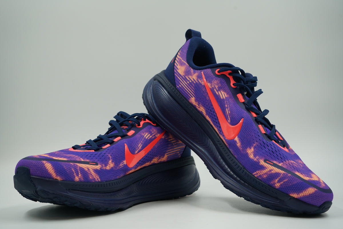 Pair of pre-owned Nike ZoomX running shoes in purple with orange print and crimson Swoosh, stacked view