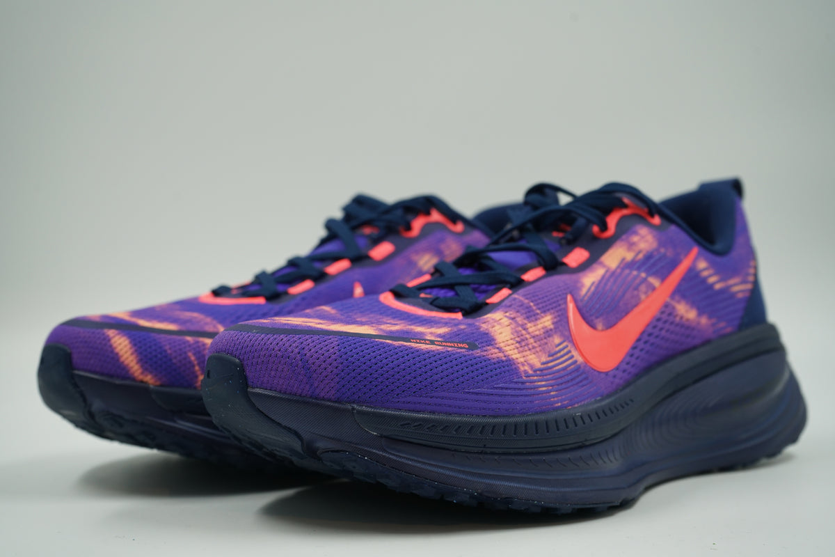 Pair of pre-owned Nike ZoomX running shoes in purple with orange print and crimson Swoosh, front angle