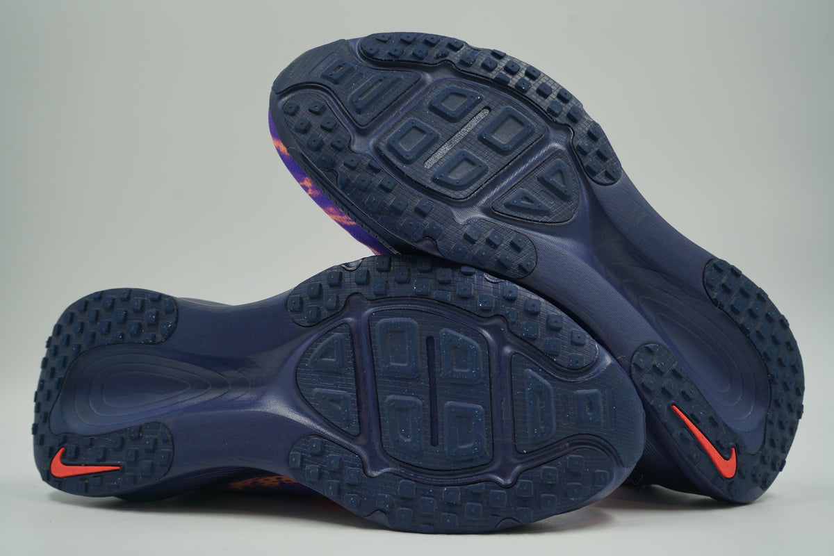 Pre-owned Nike ZoomX running shoes in purple and crimson, outsole view with navy rubber tread and Swoosh
