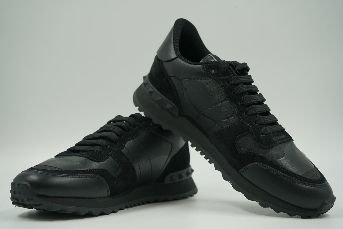 Pair of pre-owned Valentino Garavani Rockrunner in tonal black camo, stacked view of the inner sides