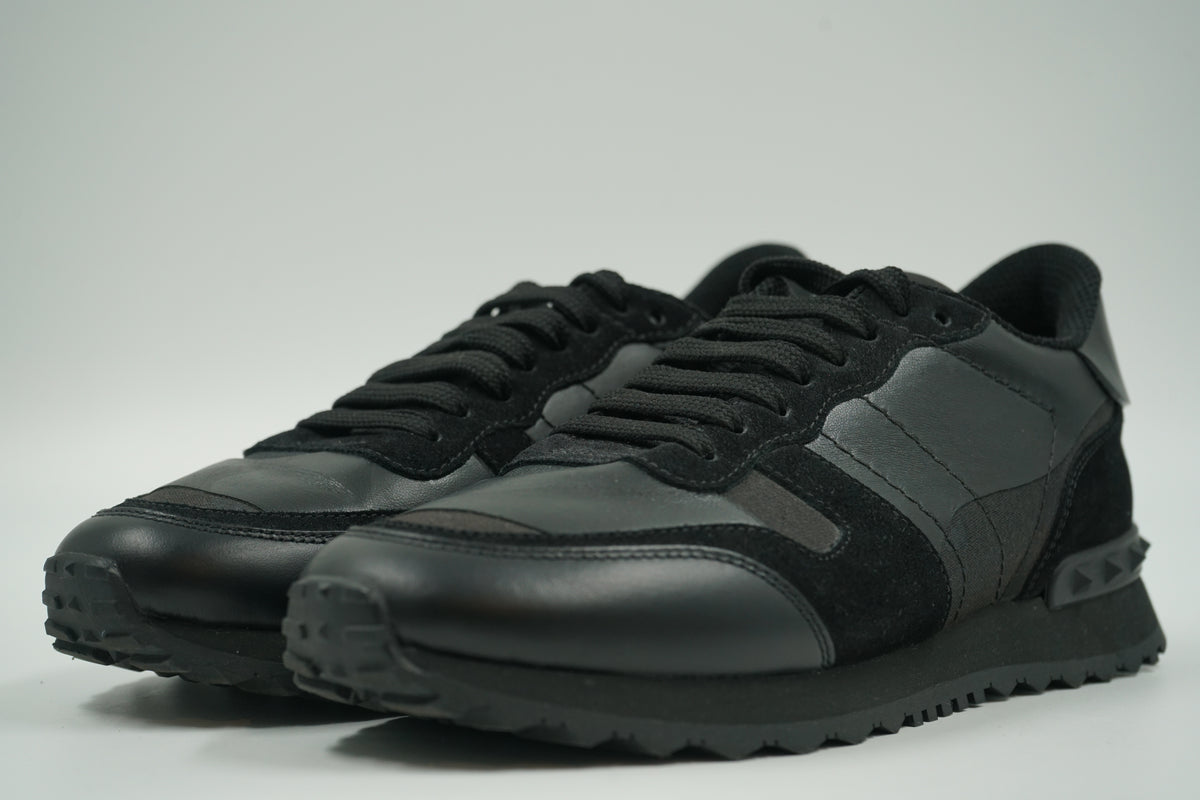 Pair of pre-owned Valentino Garavani Rockrunner in tonal black camo leather and suede, front angle view