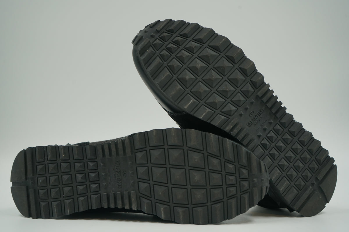 Pre-owned Valentino Garavani Rockrunner in black, outsole view with stud-pattern tread and Valentino logo