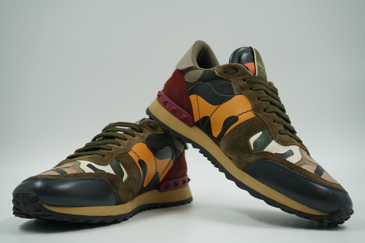 Pair of pre-owned Valentino Garavani Rockrunner camo sneakers, stacked view of inner sides with orange camo