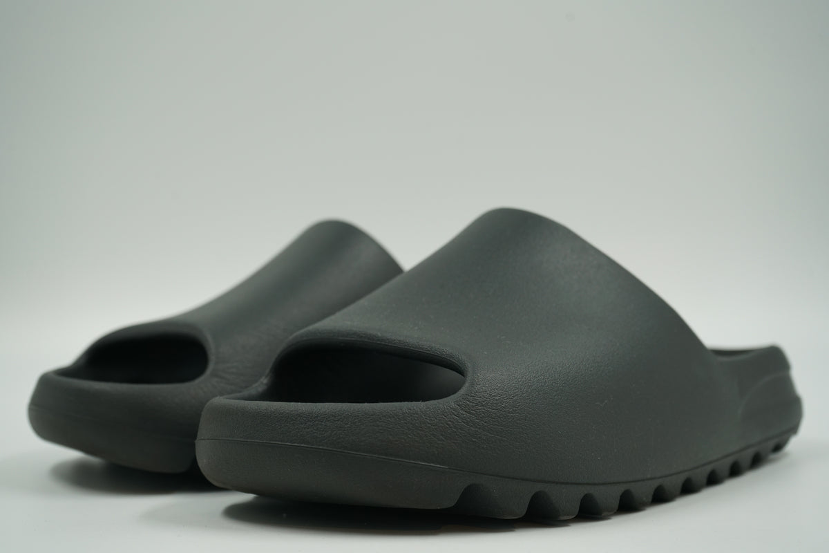 Pair of pre-owned adidas Yeezy Slides Onyx in black moulded foam